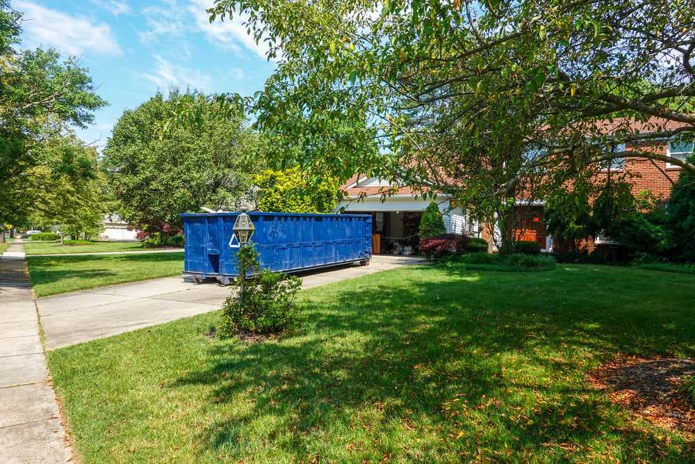 blue-dumpster-driveway-house-garage